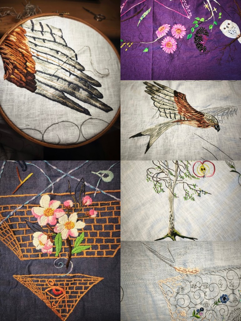 Detailreiche Handstickerei auf verschiedenen Stoffen mit Vogelmotiven, Flügeln, Blüten und symbolischen Elementen, teilweise im Stickrahmen, in unterschiedlichen Fertigungsstadien.